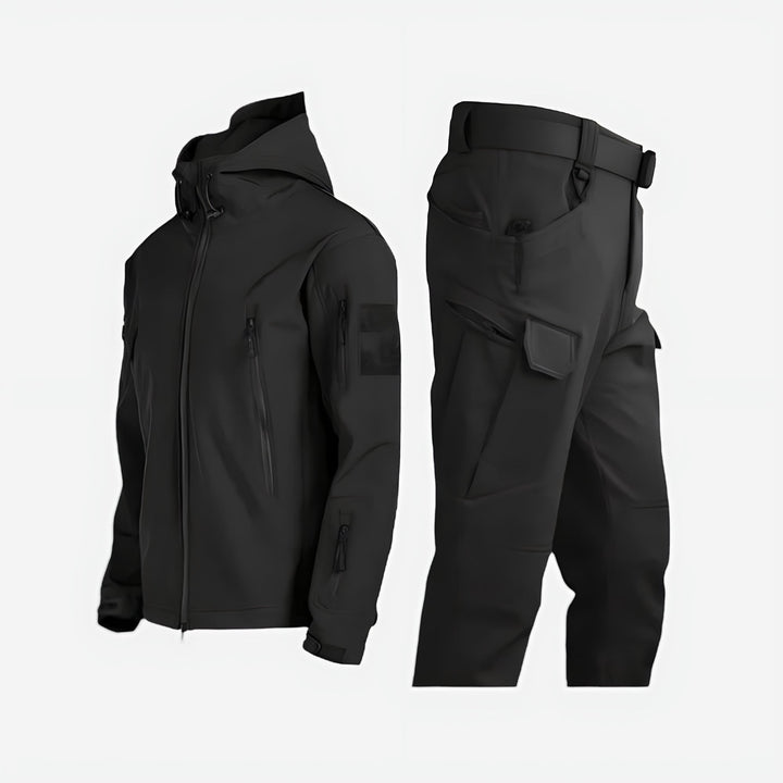 Women wearing a waterproof black outdoor jacket and pants set in a snowy winter landscape