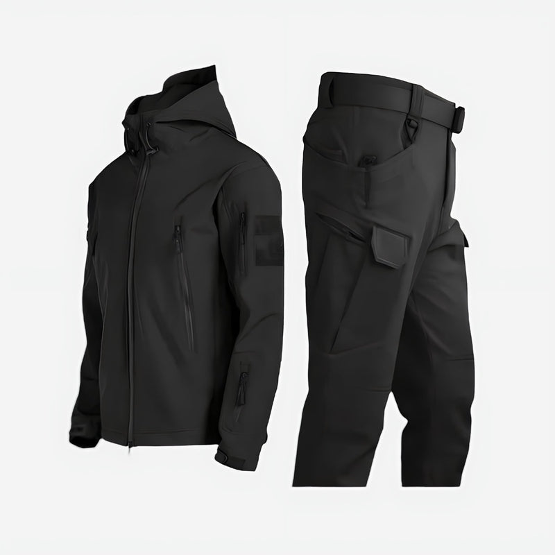 Women wearing a waterproof black outdoor jacket and pants set in a snowy winter landscape