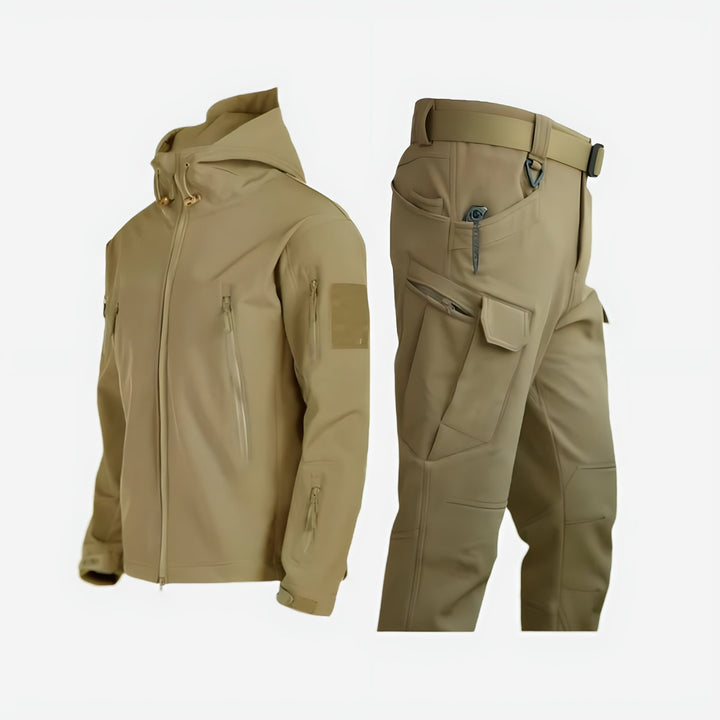 Women wearing a waterproof khaki outdoor jacket and pants set on a mountain trail