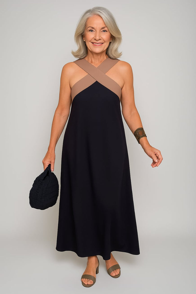 Woman wearing a black elegant cross-neck maxi dress with a flowing silhouette and crisscross neckline