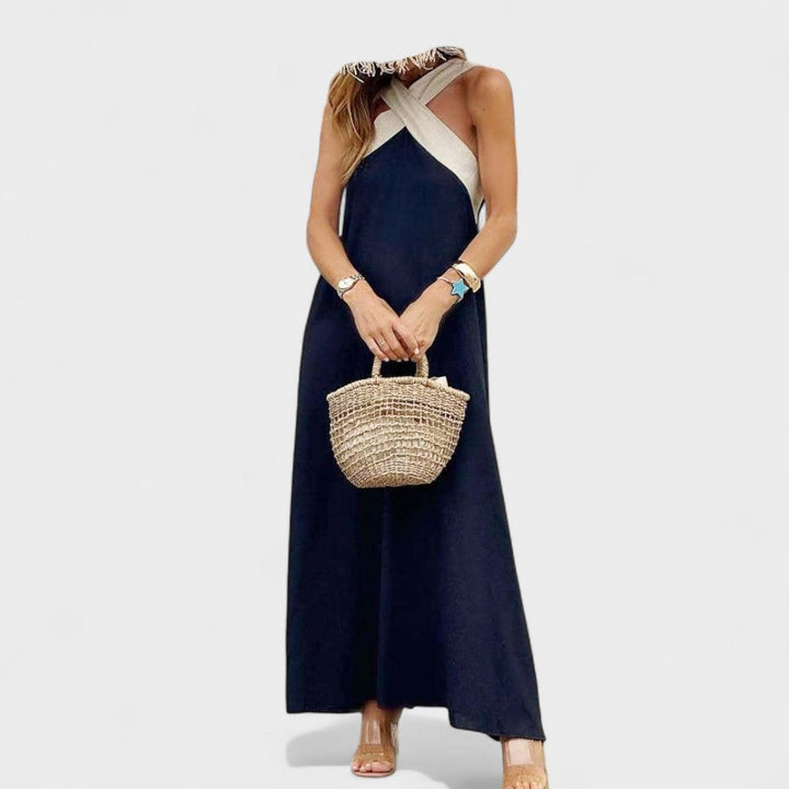Full-length view of a woman in a white cross-neck maxi dress showing the airy, flowing fit