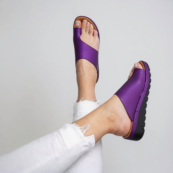 Suki sandal in Purple worn on foot, showcasing sleek silhouette and cushioned sole