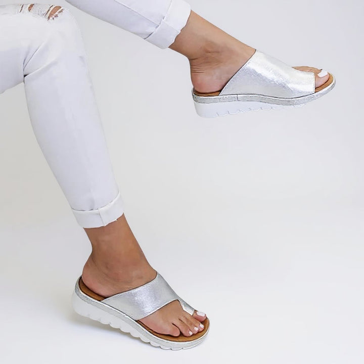 Flat lay of Suki sandals in multiple colors: Black, Yellow, Khaki, Silver, and Leopard