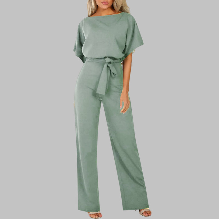 Full-length shot of the Sunny wide-leg jumpsuit in apricot with batwing sleeves and tied waist belt