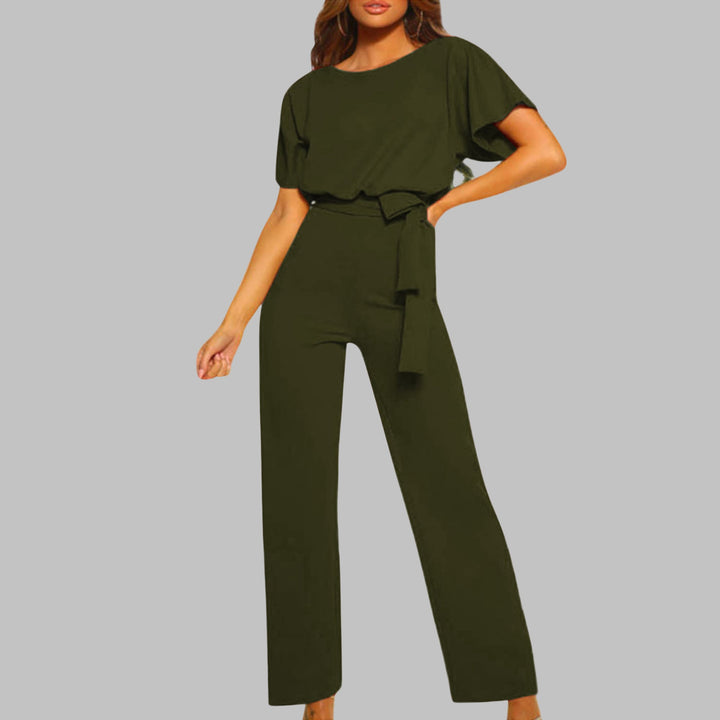 Woman posing in the Sunny belted jumpsuit in burgundy showing the elongating wide-leg cut