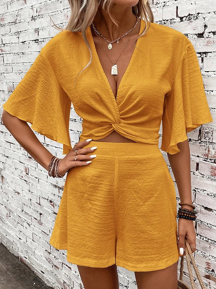 Front view of Sunny two-piece set showing V-neck twist crop top and matching high-waist shorts in dark green