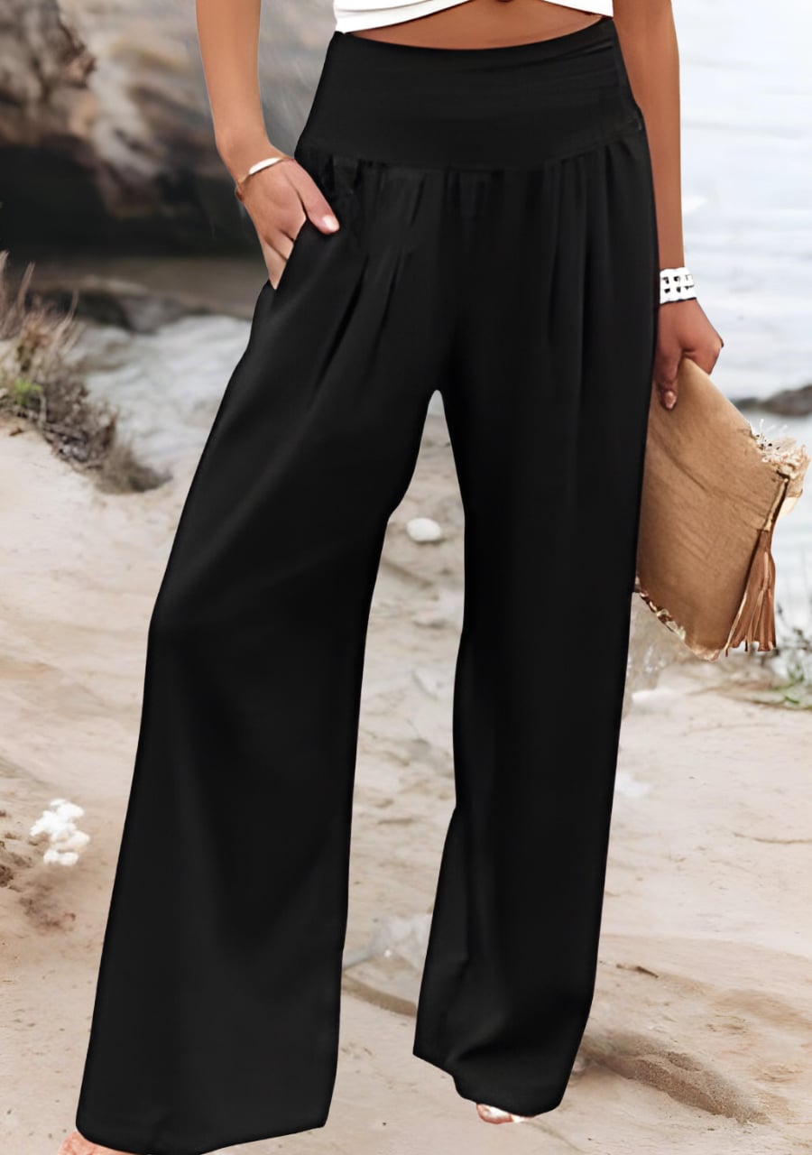 Close-up detail of the stretchy gathered waistband on lightweight wide-leg beach pants in white