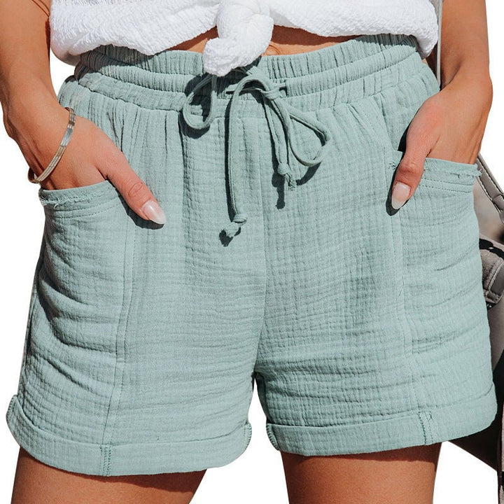 Model showing the back view of wide-leg summer shorts in a light, airy fabric