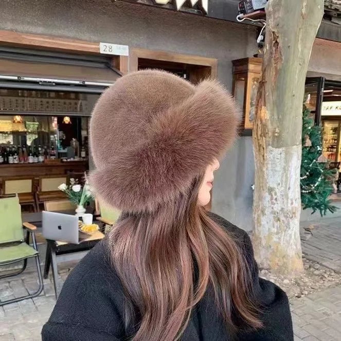 Close-up of a cozy fluffy winter hat in a neutral tone showing plush texture and sculpted silhouette