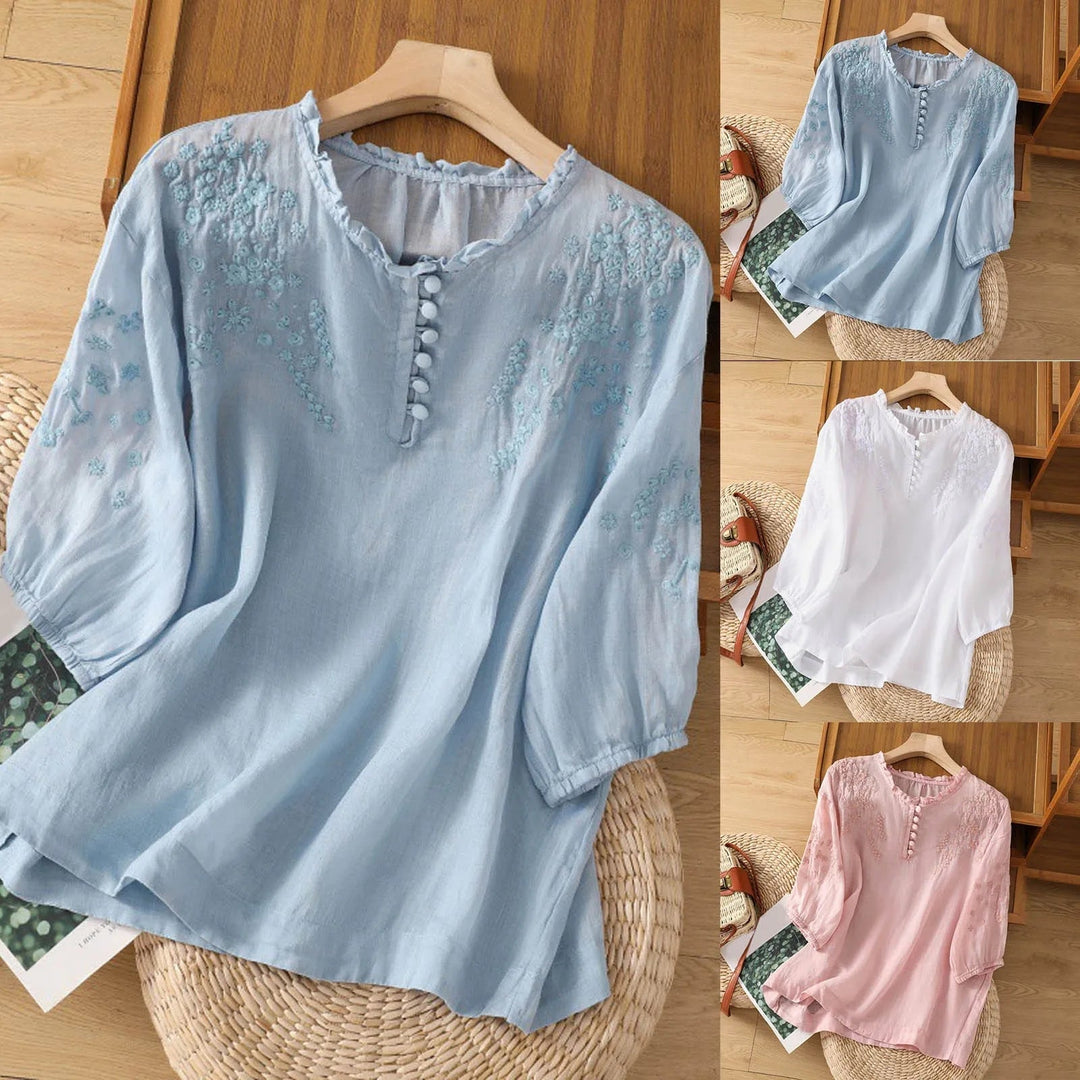 Woman wearing a floral button-front blouse paired with denim jeans for a casual everyday look
