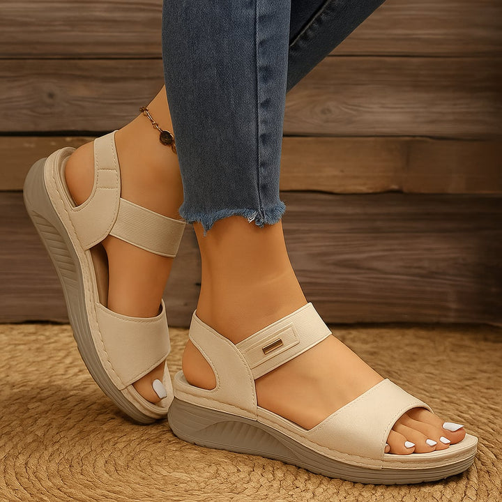 Swift women's adjustable sandals in beige displayed flat on a light surface, top view
