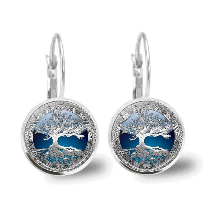 Close-up of silver tree of life hoop earrings showing intricate detailing and polished silver-tone finish