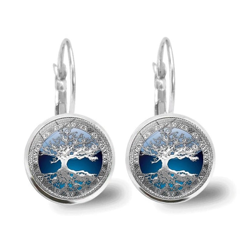 Close-up of silver tree of life hoop earrings showing intricate detailing and polished silver-tone finish