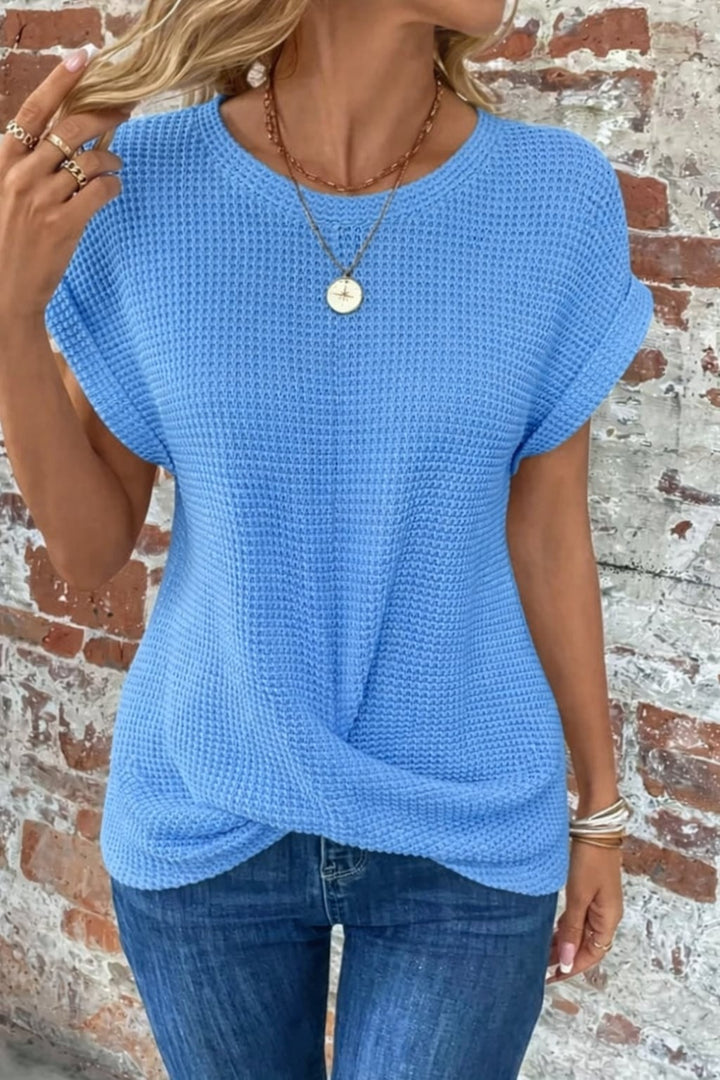 Flat lay of waffle knit casual tee showing texture and rolled sleeve detail