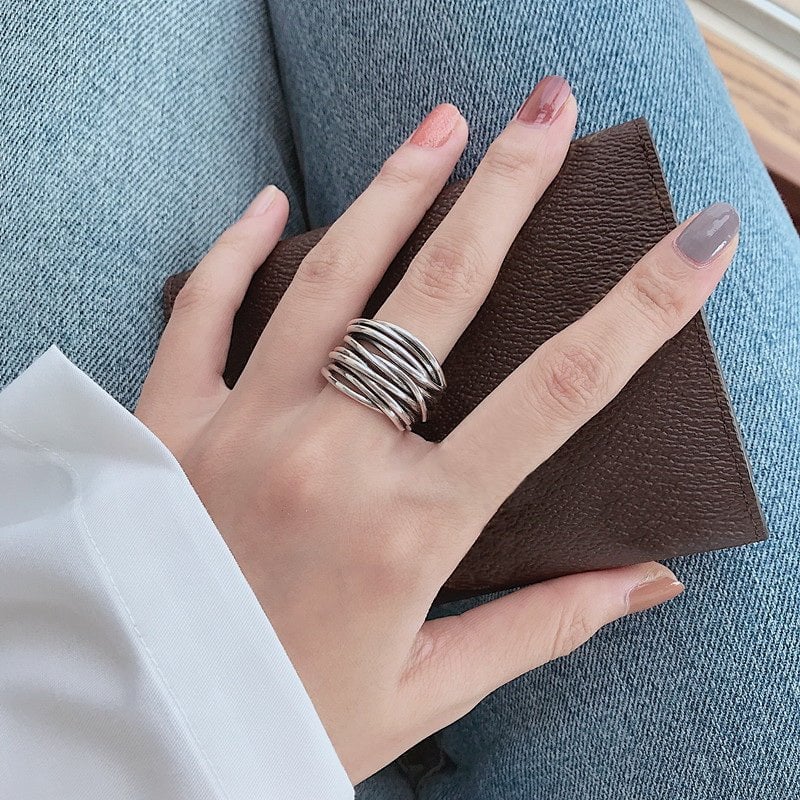 Close-up of sterling silver adjustable layered ring highlighting the multi-layer detail and polished finish