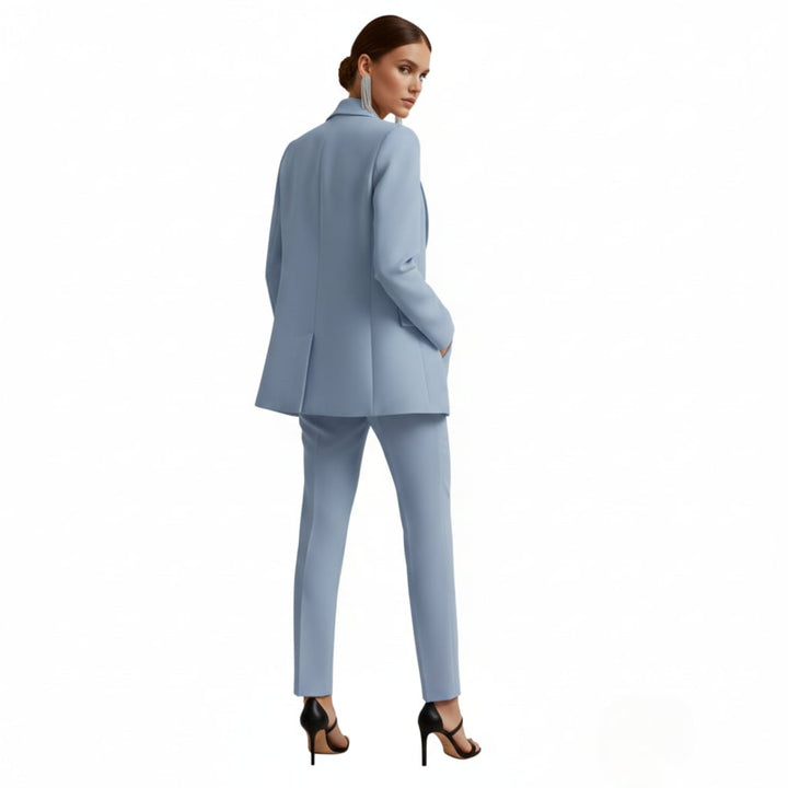 Close-up of double breasted button closure on light blue women's blazer suit set