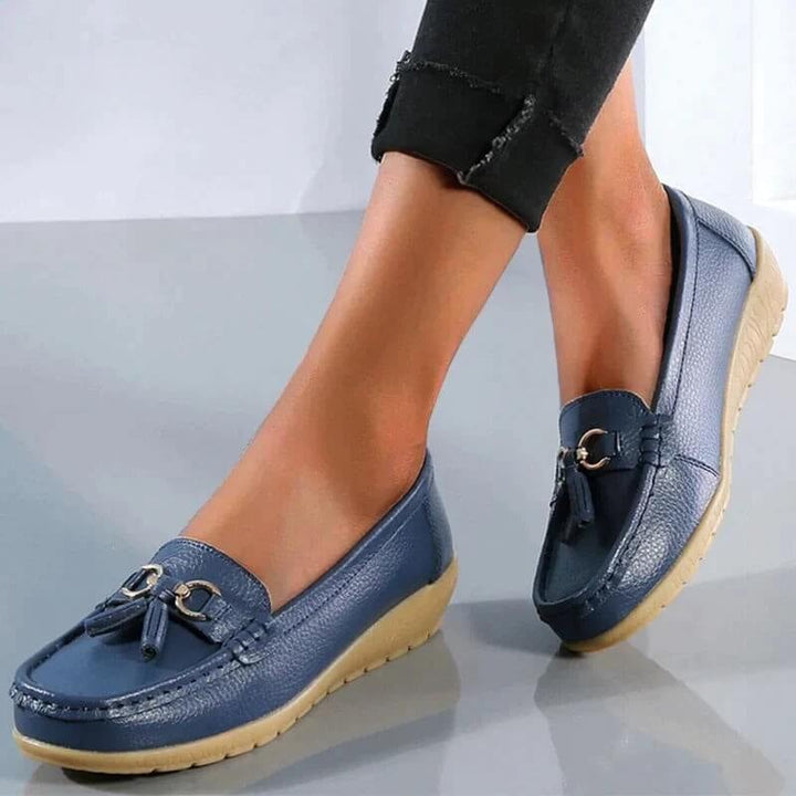 Talia tassel loafers in light blue shown from the side, highlighting the smooth leather-look upper