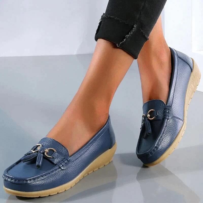 Talia tassel loafers in light blue shown from the side, highlighting the smooth leather-look upper
