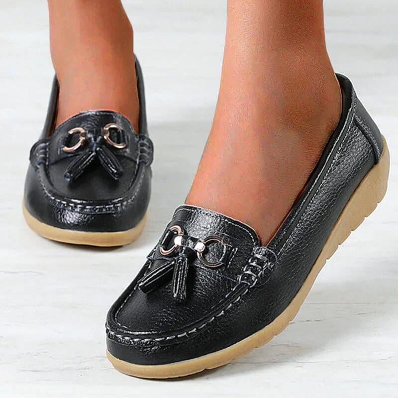 Close-up of gold tassel and chain hardware detail on the Talia slip-on loafer