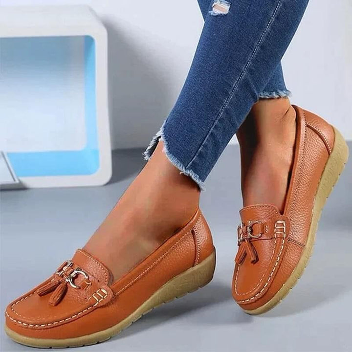 Talia tassel loafers in black, side profile showing contrast topstitching and flat sole