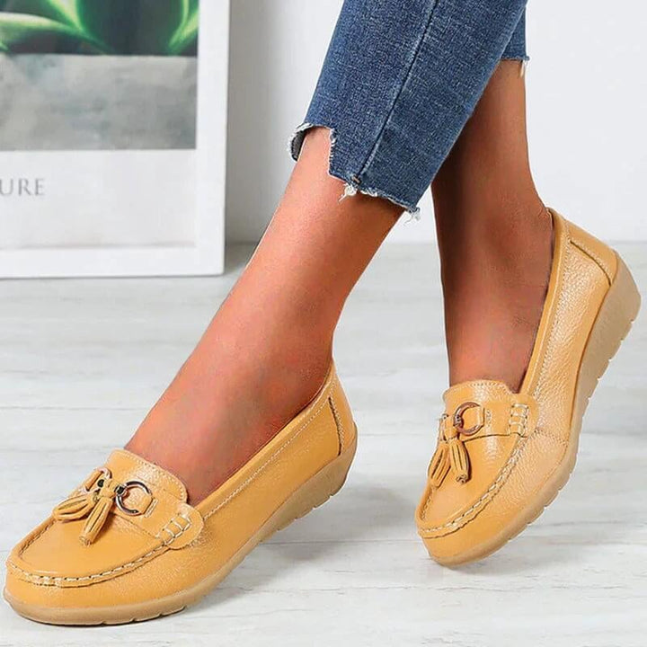 Talia loafers in brown worn on feet, styled with straight-leg jeans