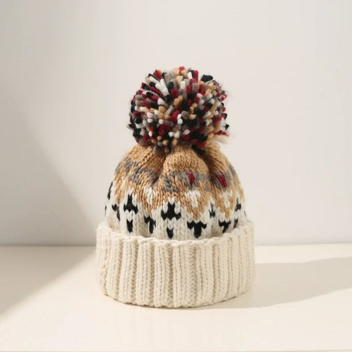 Sky blue knit snowflake beanie with plush pom-pom detail