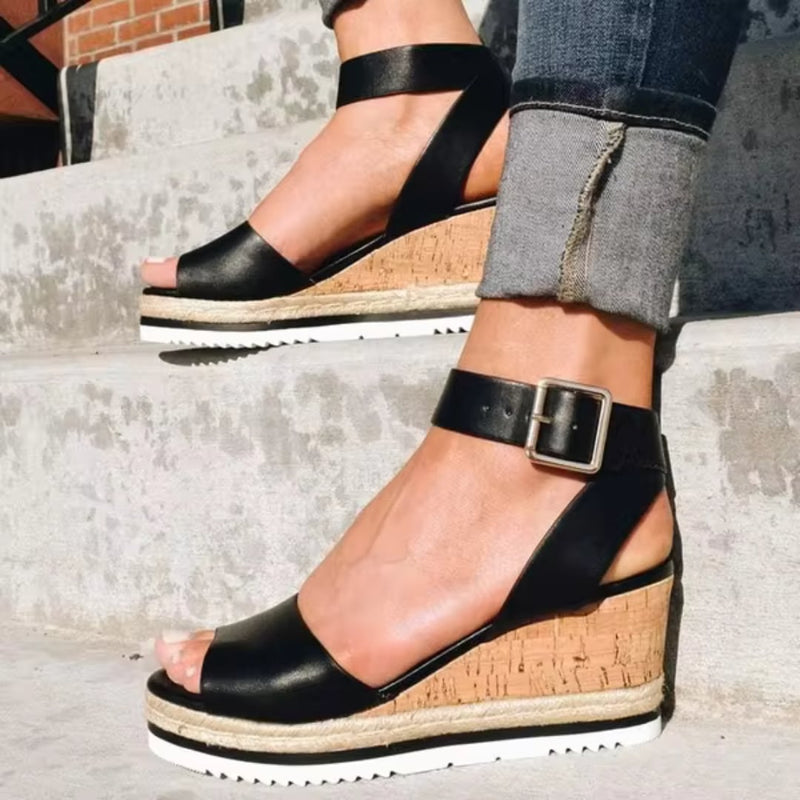 Tamsin women's wedge sandals in black with sleek straps and cushioned insole, side profile view