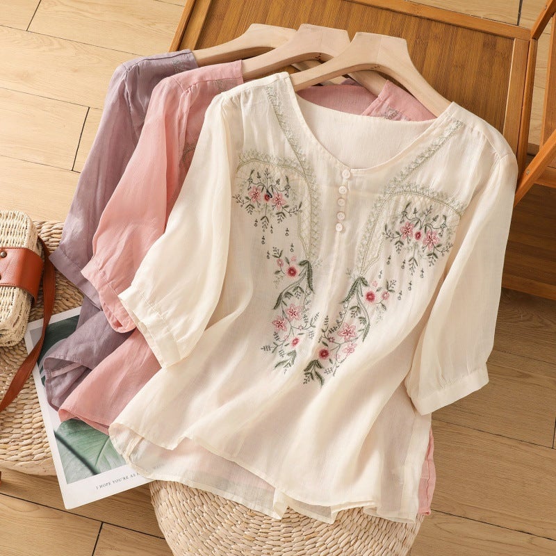 Relaxed floral embroidered blouse with button V-neckline in purple, shown on model from front