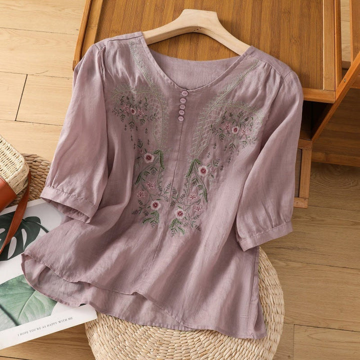 Floral embroidered blouse in beige with loose sleeves, styled with high-waisted pants