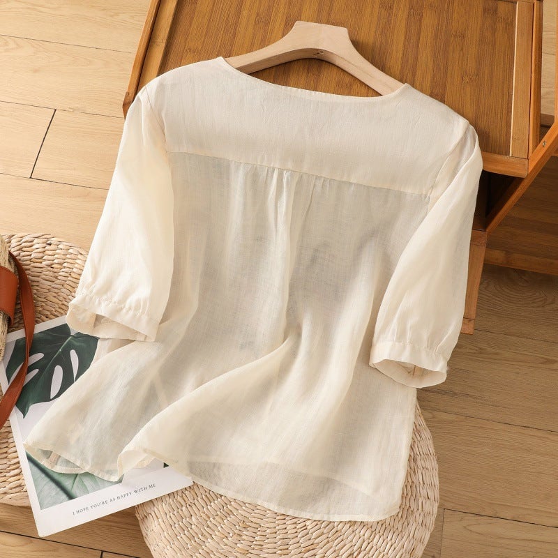 Side view of floral embroidered blouse showing relaxed silhouette and breezy sleeve detail
