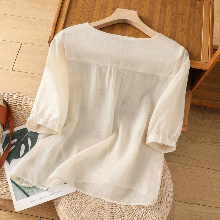 Side view of floral embroidered blouse showing relaxed silhouette and breezy sleeve detail