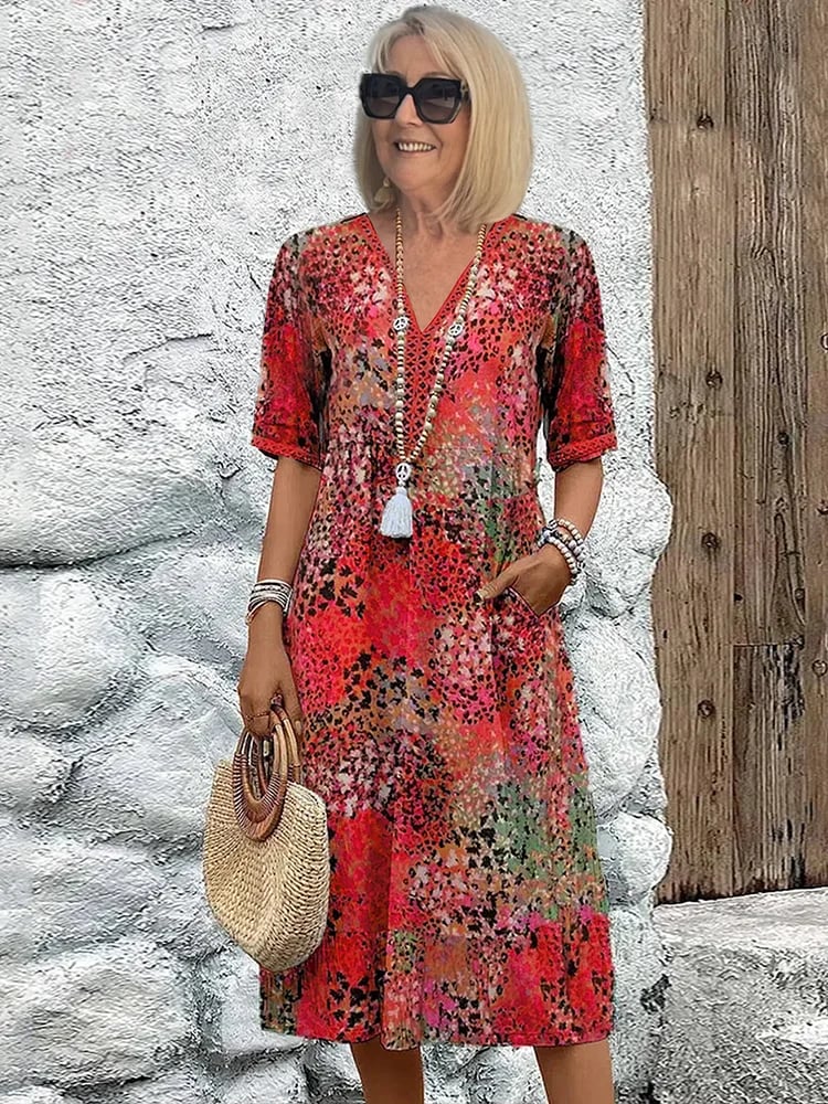 Model wearing the Tanya colorful midi dress in Scarlet Red with a flowy silhouette and bold pattern