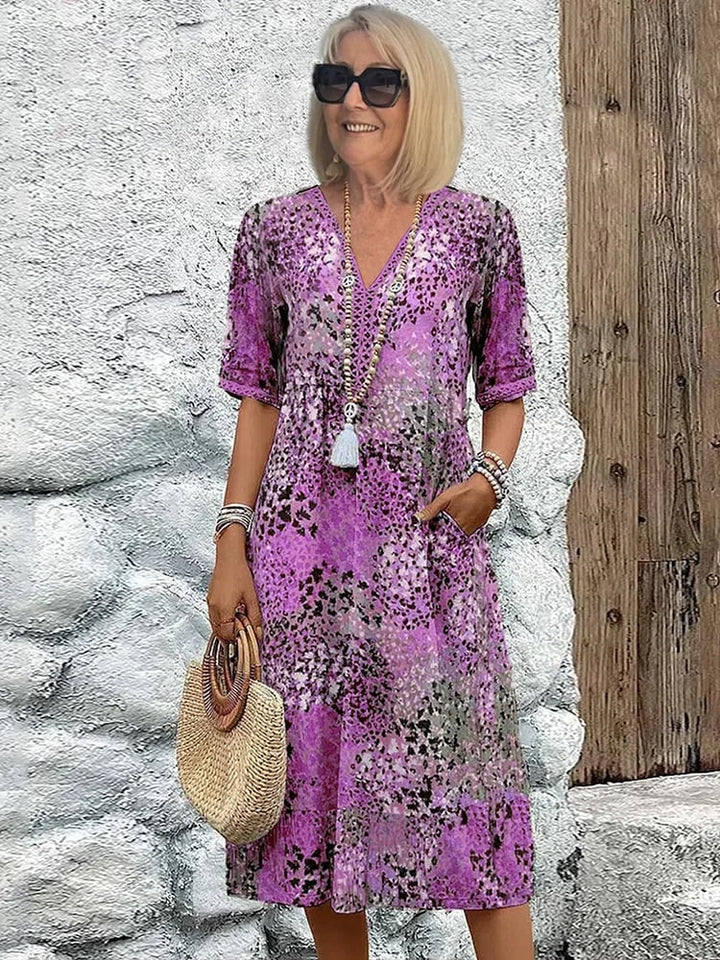 Model styling the Tanya midi dress in Ocean Blue with sandals for a casual daytime look