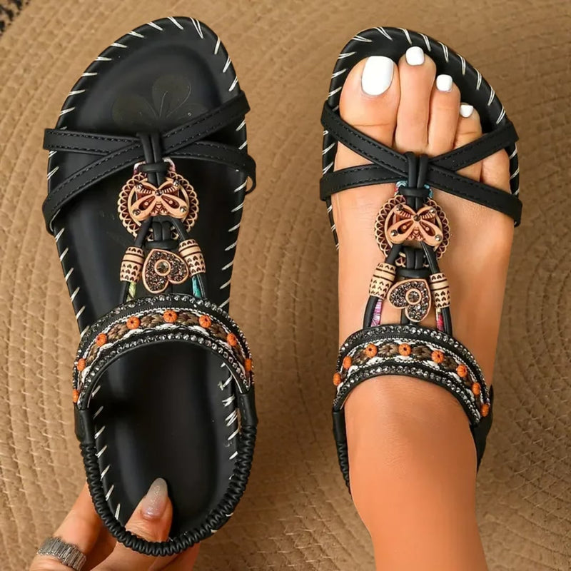 Tara orthopedic sandals in black worn on a summer sidewalk