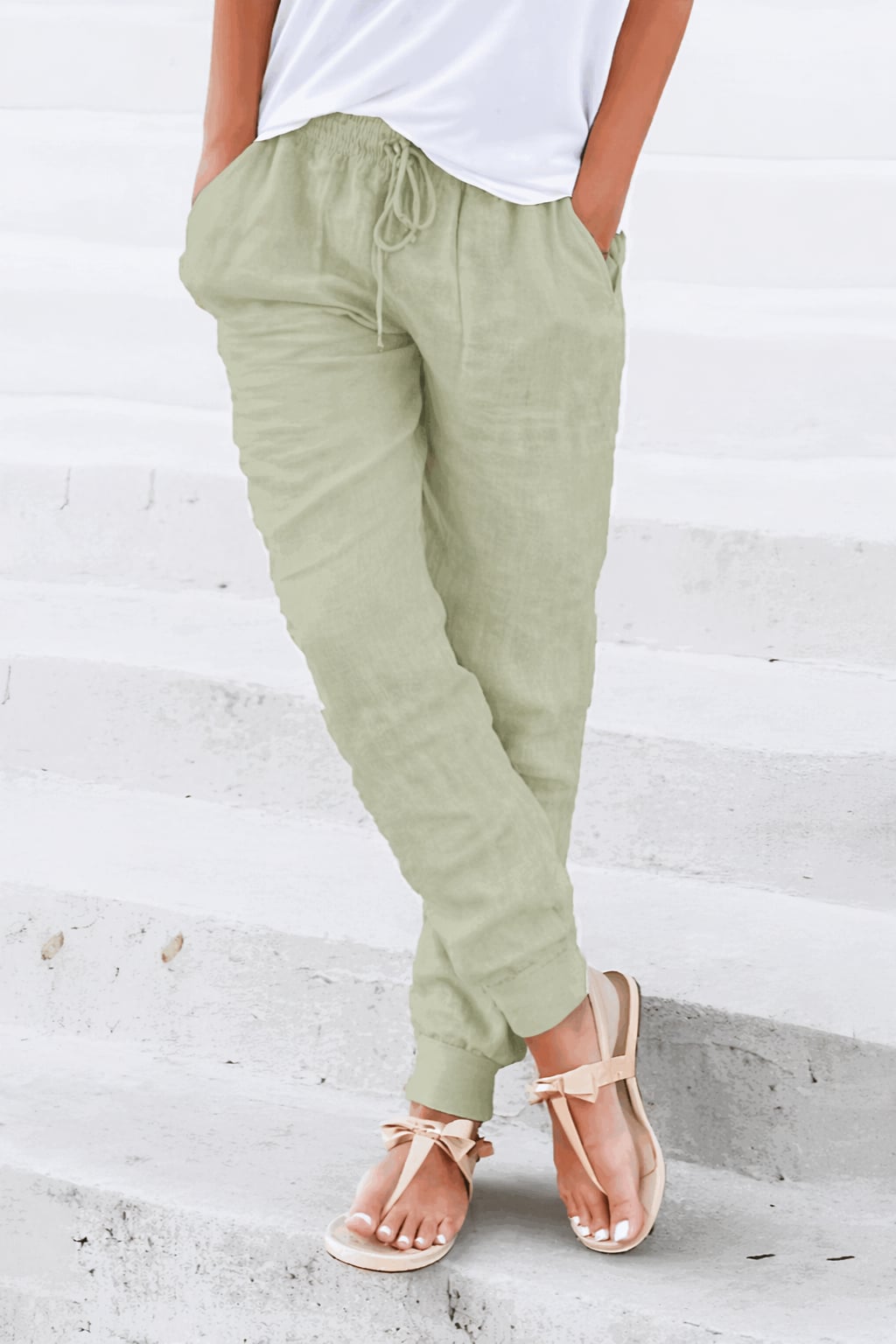 Women's black jogger pants side view highlighting tapered silhouette and ankle cuffs