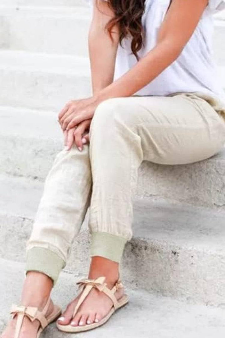 Women's green drawstring jogger pants with side pockets, front view