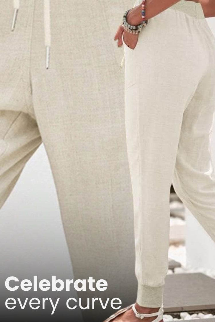 Flat lay of women's drawstring jogger pants showing tapered leg and elastic cuffs detail