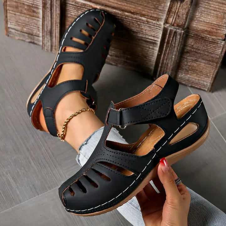 Tatum sandals in white displayed at an angle to highlight sleek silhouette and sole cushioning