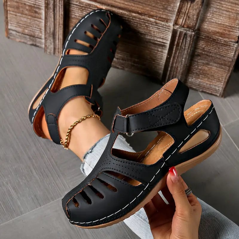 Tatum sandals in white displayed at an angle to highlight sleek silhouette and sole cushioning