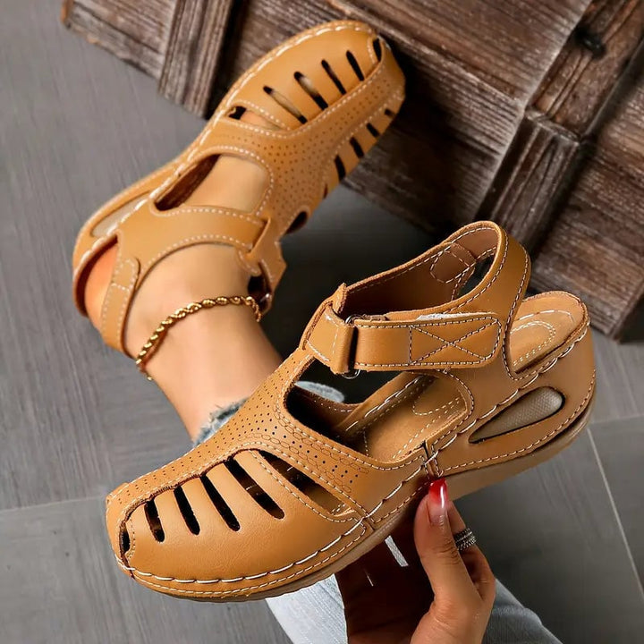 Tatum sandals in brown flat lay on a neutral surface showing full sole and strap construction