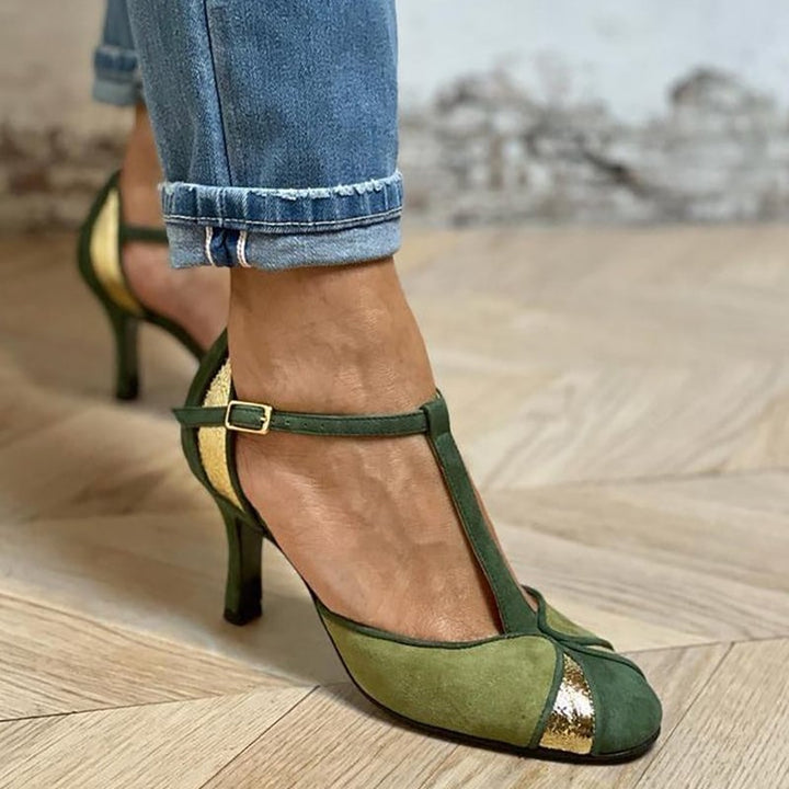 Front view of green patchwork closed toe T-strap heels on a white background