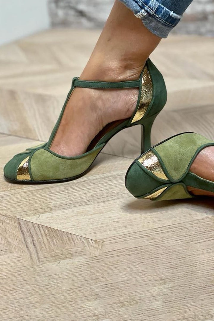 Side profile of green patchwork T-strap heels showing heel height and closed toe silhouette