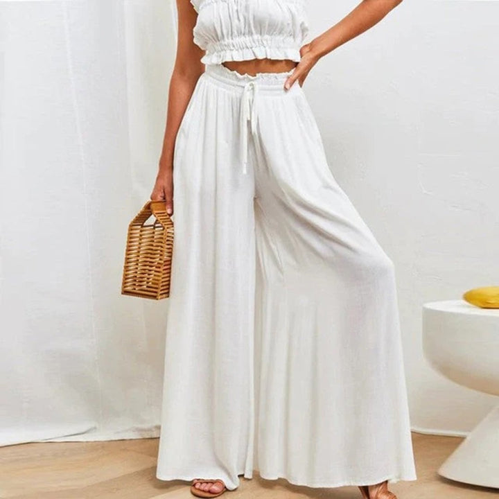Front view of Terra high waist wide leg smocked drawstring pants in a neutral color on a female model