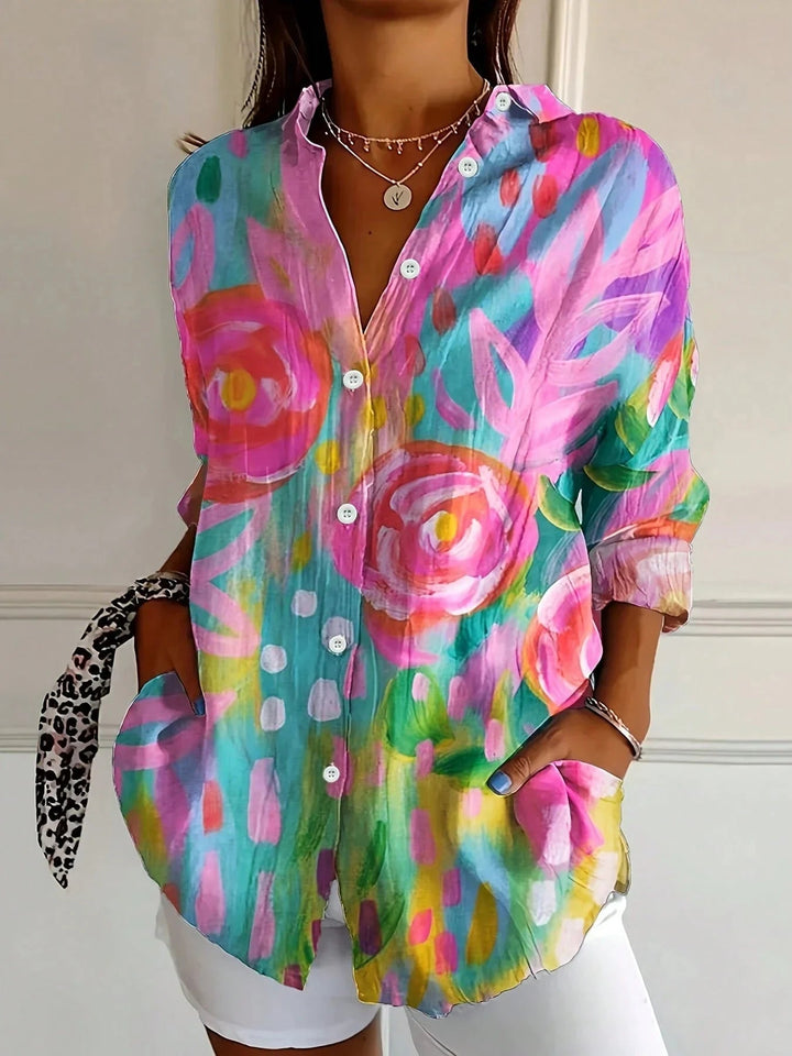 Woman wearing a colorful all-over print blouse in a relaxed, airy fit