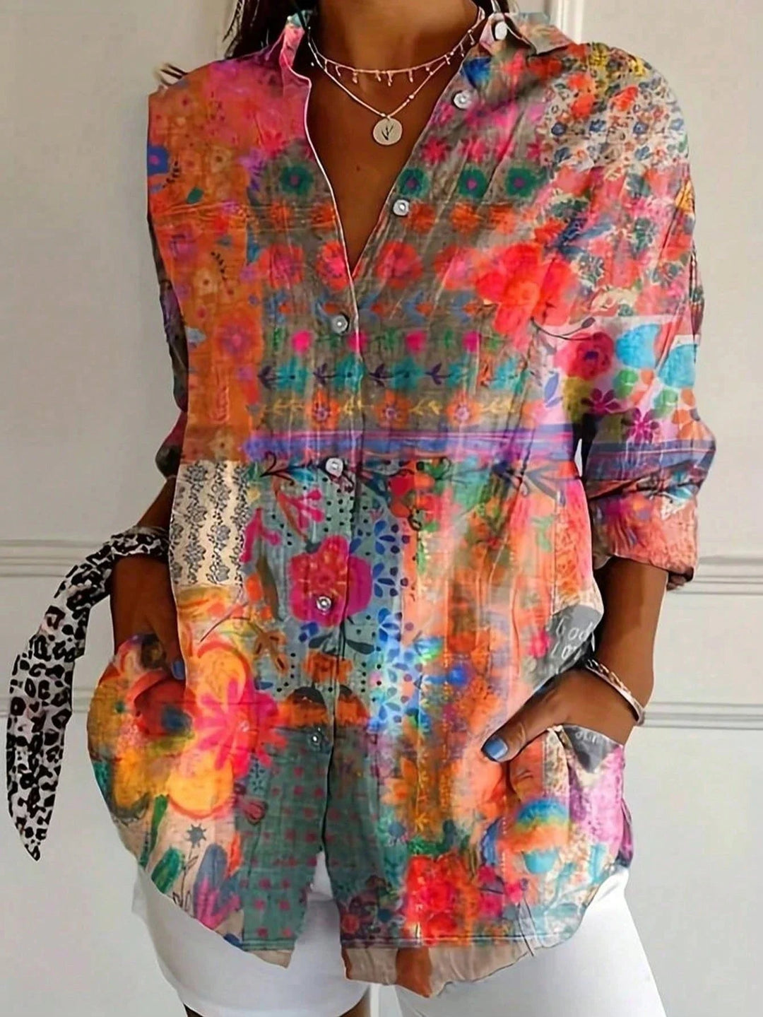 Front view of a vibrant printed blouse with playful pattern in pink tones