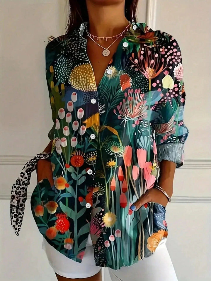 Model styled in a bright printed blouse paired with casual bottoms