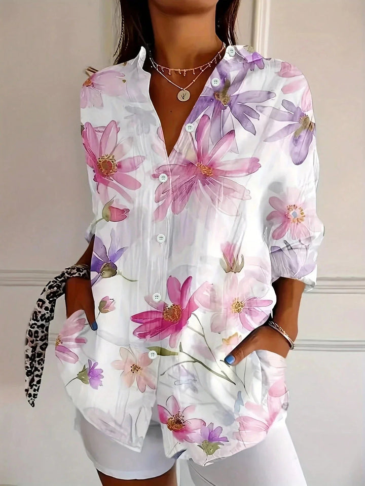 Close-up of the colorful all-over print detail on a lightweight blouse