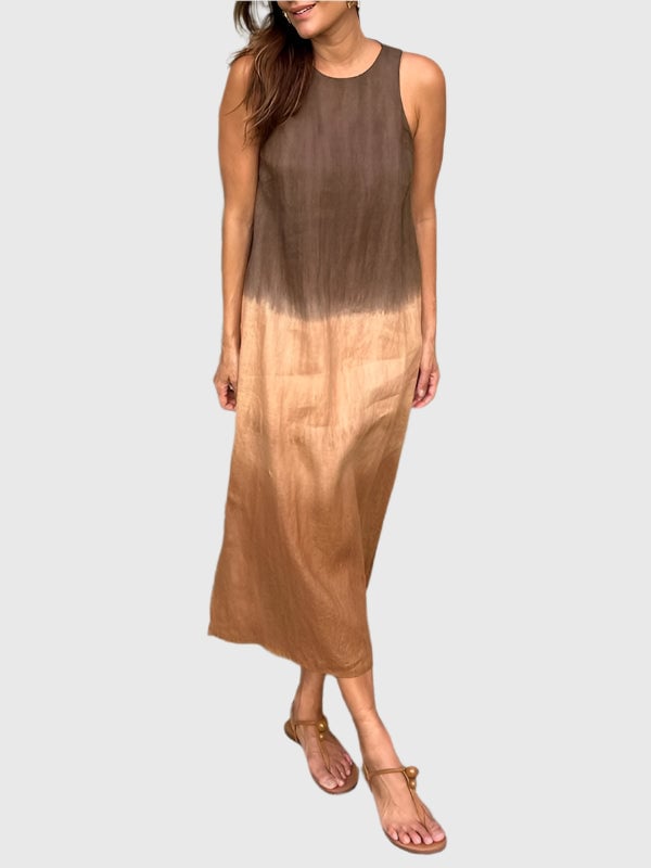 Woman wearing a flowing printed dress with an elegant earthy print in a relaxed flattering silhouette