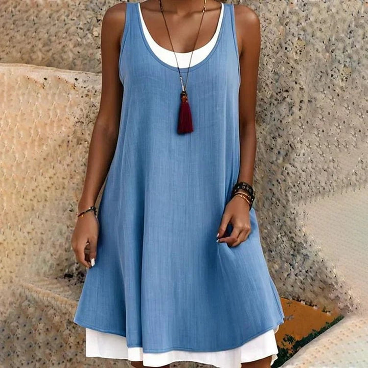 Front view of the Tessa layered mini dress showing the faux two-piece design and relaxed swing hem in blue