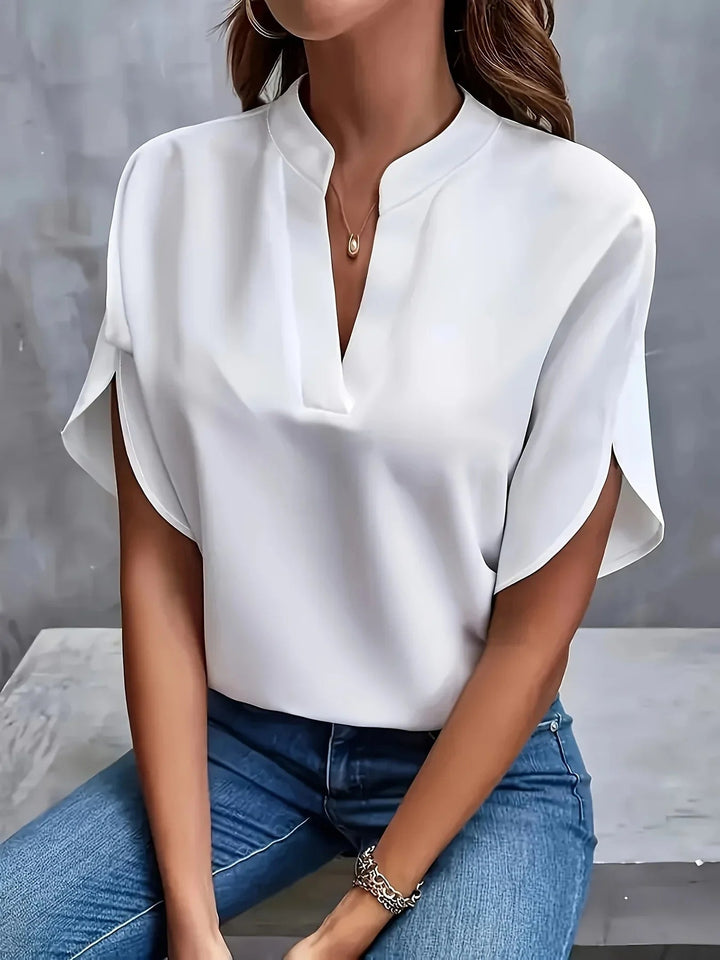 Close-up of the tailored V-neckline and cap sleeve detailing on a chic, lightweight blouse from Florimay